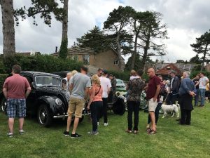visitors admiring the classic cars
